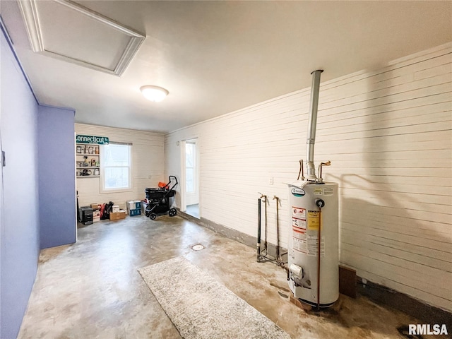 interior space featuring water heater and brick wall