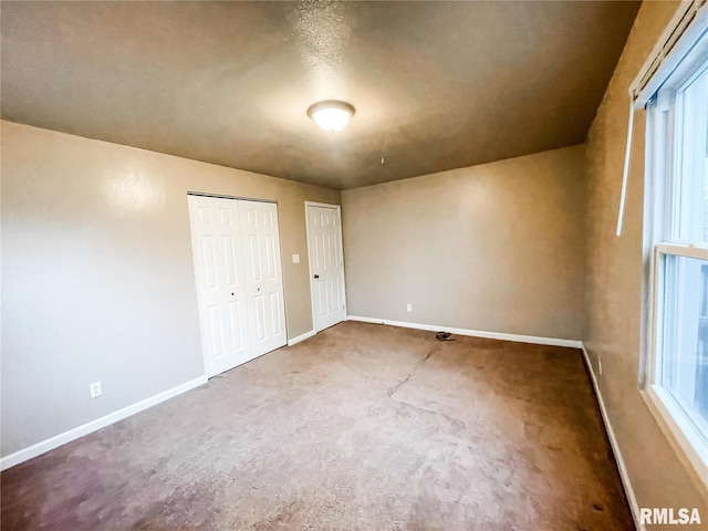 unfurnished bedroom with carpet flooring and multiple closets