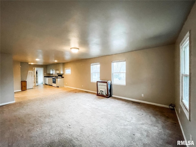 unfurnished living room with light carpet