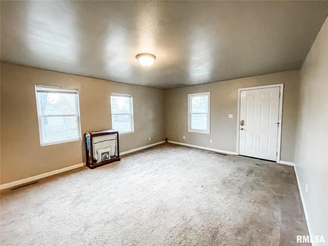 spare room with carpet and plenty of natural light