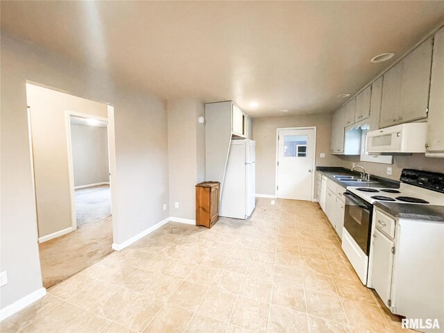 kitchen featuring white cabinets, white appliances, light tile patterned flooring, and sink