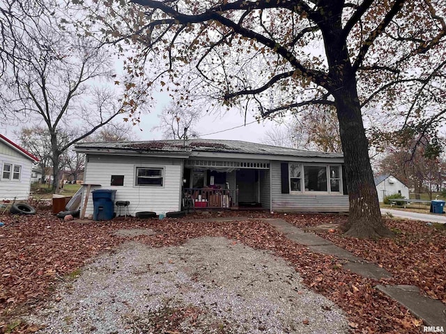 rear view of property featuring a porch