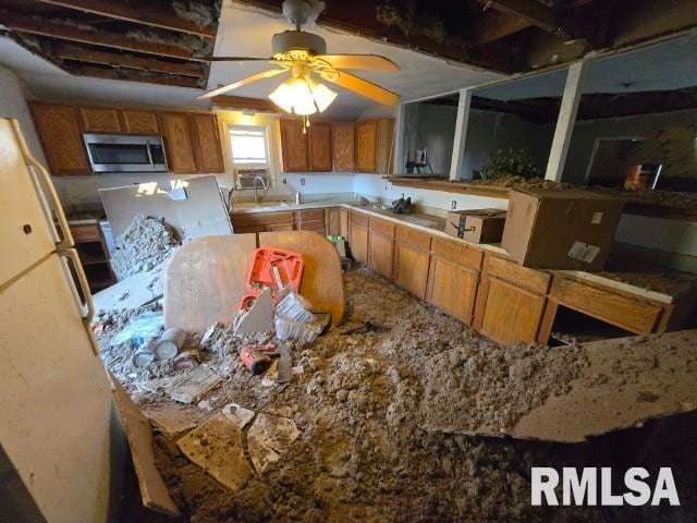 kitchen with ceiling fan and light stone countertops