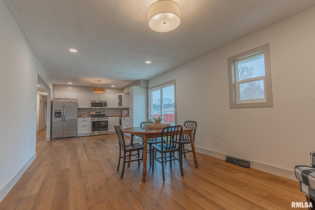 dining space featuring light wood-type flooring