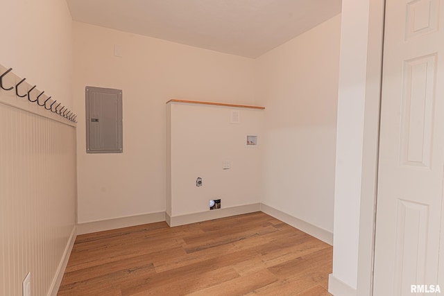 laundry area featuring hookup for a washing machine, light hardwood / wood-style floors, and electric panel