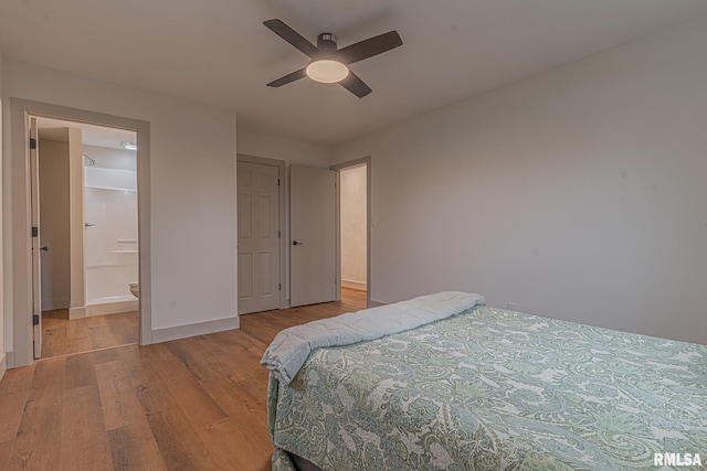 bedroom featuring a closet, ensuite bath, ceiling fan, and light hardwood / wood-style flooring