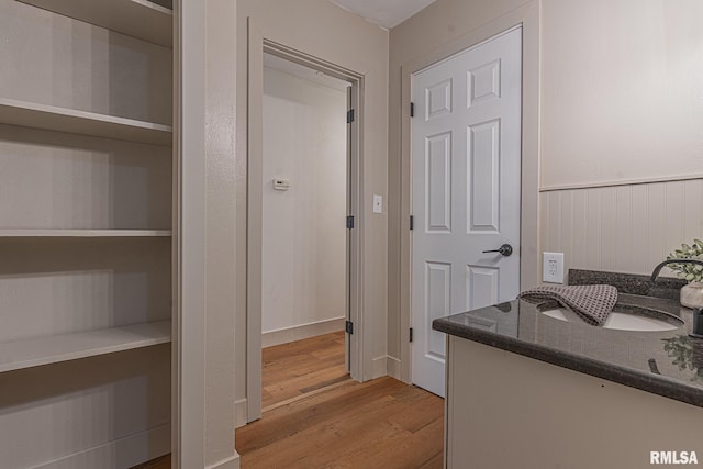 bathroom with hardwood / wood-style floors and sink