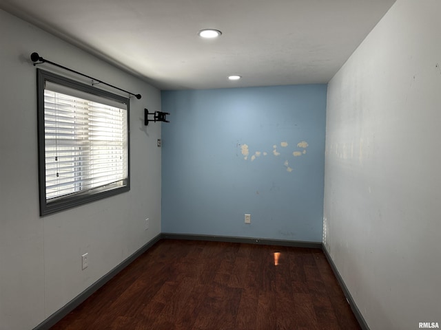 spare room featuring dark wood-type flooring