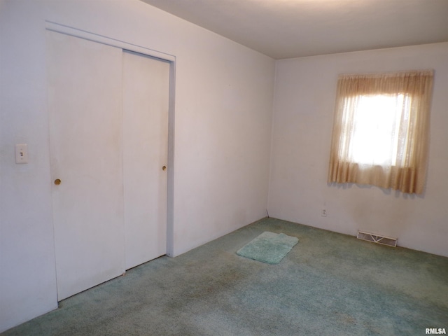 unfurnished bedroom featuring a closet and carpet floors