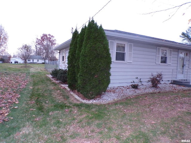 view of side of home featuring a yard