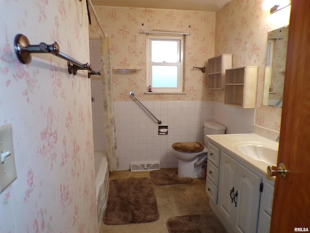 full bathroom with vanity, toilet, tile walls, and tub / shower combination