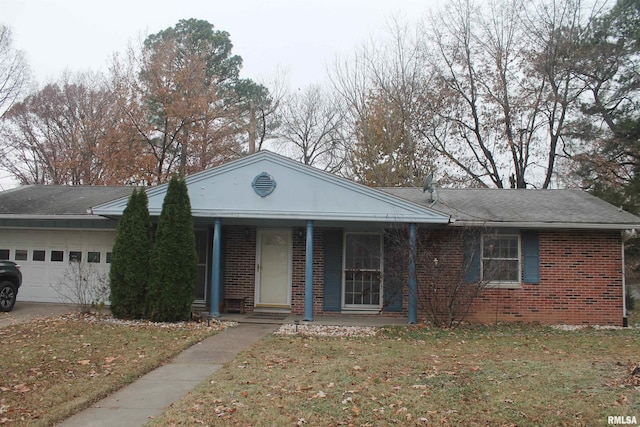 view of front of house with a porch, a garage, and a front lawn