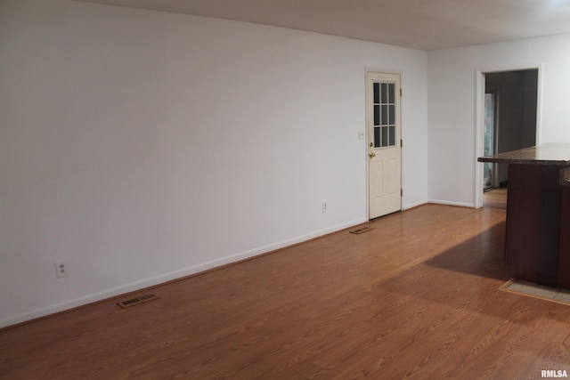 empty room with wood-type flooring