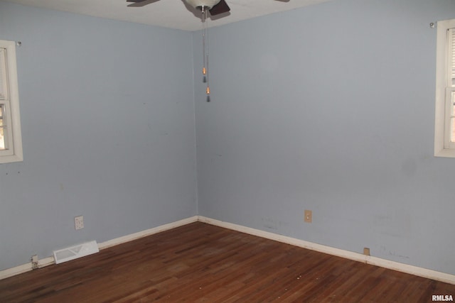 unfurnished room with ceiling fan and dark hardwood / wood-style flooring