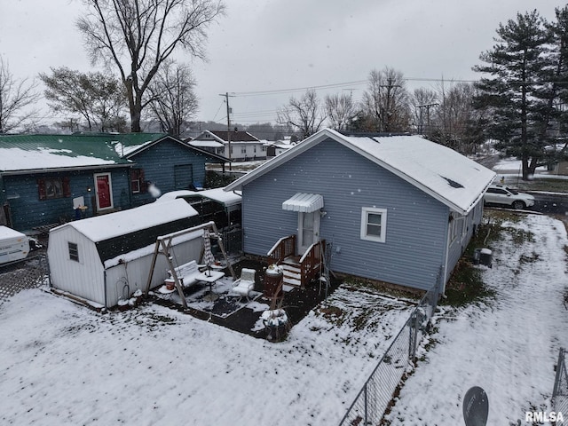 snow covered property with cooling unit