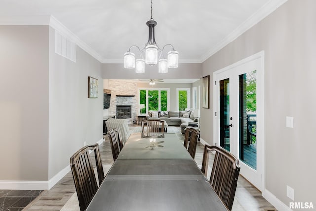 12225 Pebble Point Rd, Marion, IL 62959 - dining space with a chandelier, baseboards, crown molding, and a fireplace