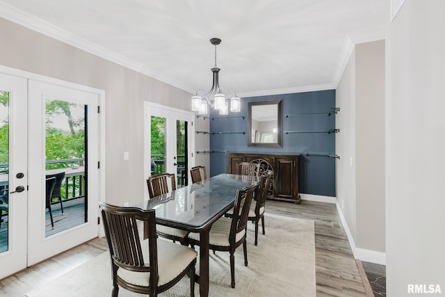 12225 Pebble Point Rd, Marion, IL 62959 - dining space featuring french doors, plenty of natural light, crown molding, a chandelier, and light wood-type flooring