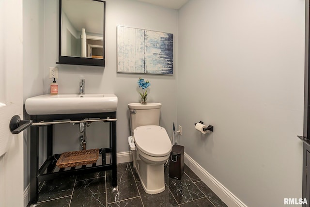 bathroom featuring toilet and sink