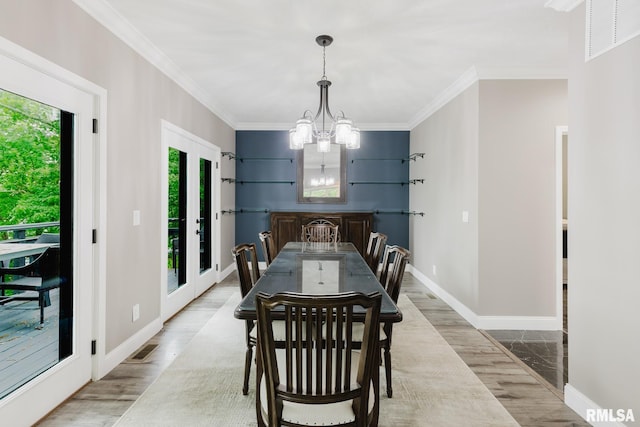 12225 Pebble Point Rd, Marion, IL 62959 - dining room featuring wood finished floors, a chandelier, crown molding, and baseboards