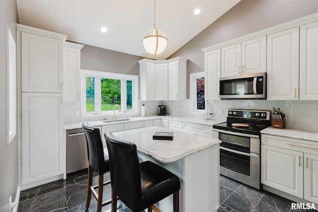 12225 Pebble Point Rd, Marion, IL 62959 - kitchen with stainless steel appliances, dark marble finish flooring, a sink, lofted ceiling, and white cabinets