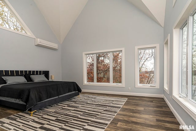 bedroom with dark hardwood / wood-style flooring, high vaulted ceiling, and a wall mounted AC