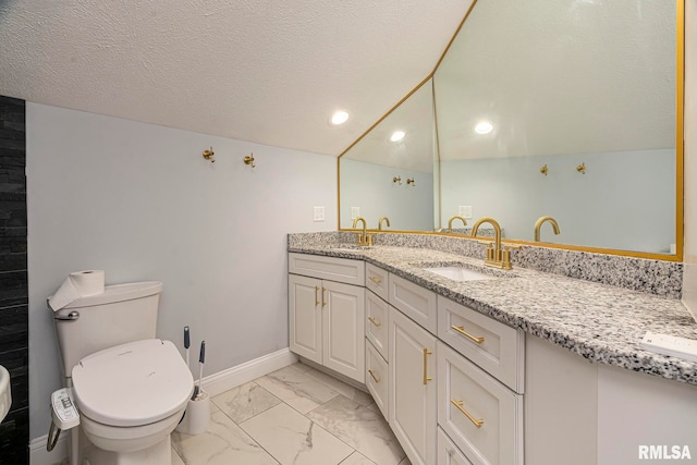 bathroom featuring vanity, toilet, a textured ceiling, and vaulted ceiling