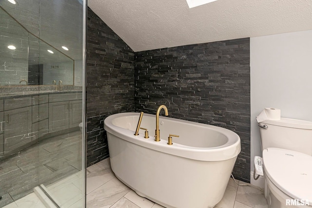 bathroom featuring a washtub, vanity, a textured ceiling, toilet, and lofted ceiling