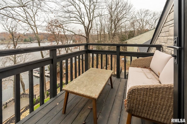 wooden terrace featuring a water view