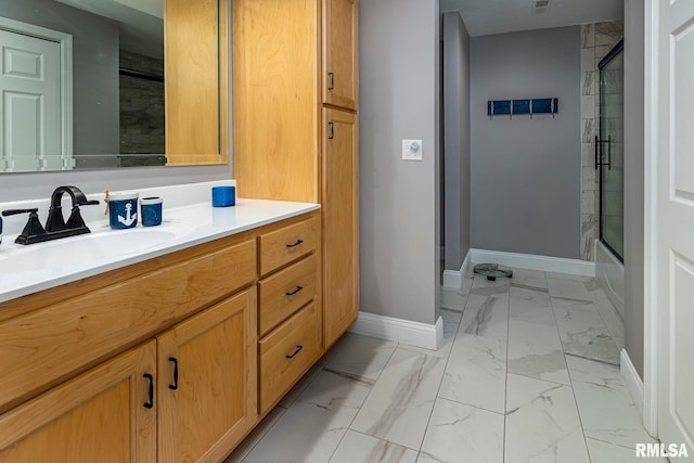 bathroom featuring shower / bath combination with glass door and vanity