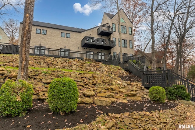 back of property with a balcony