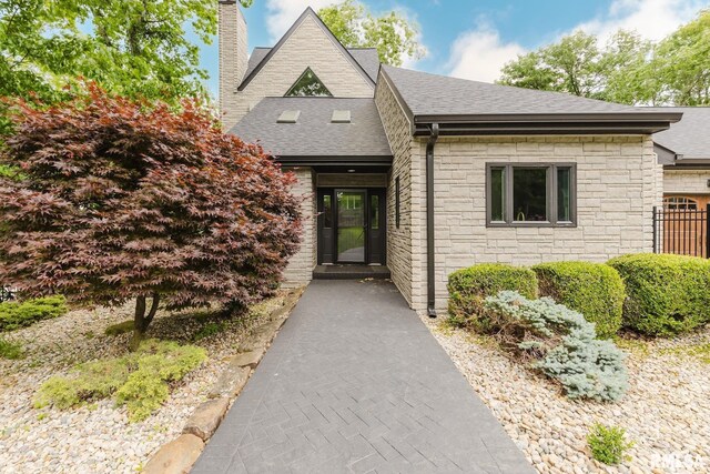 12225 Pebble Point Rd, Marion, IL 62959 - property entrance with stone siding, a chimney, and a shingled roof