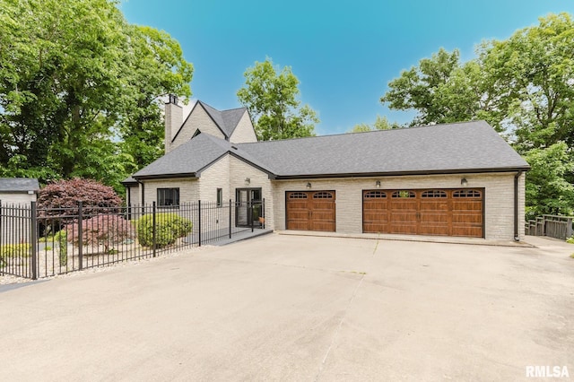 12225 Pebble Point Rd, Marion, IL 62959 - view of front of house with driveway, a chimney, brick siding, roof with shingles, and a garage