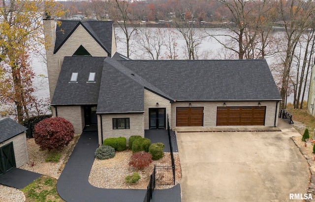 view of front of house with a water view and a garage