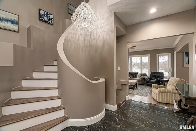 staircase with ceiling fan with notable chandelier and crown molding