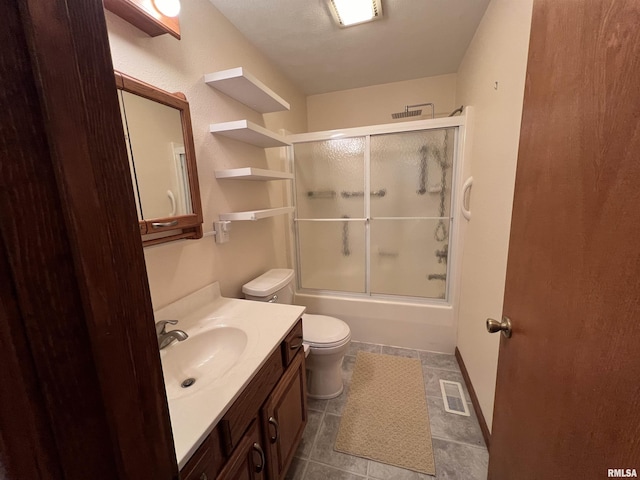 full bathroom with tile patterned floors, vanity, toilet, and enclosed tub / shower combo