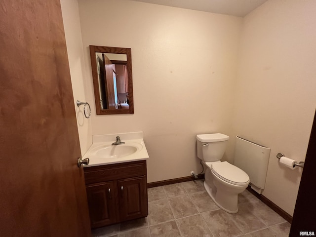 bathroom with tile patterned flooring, vanity, and toilet