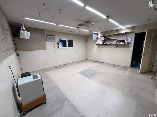 garage featuring a wall mounted air conditioner and ceiling fan