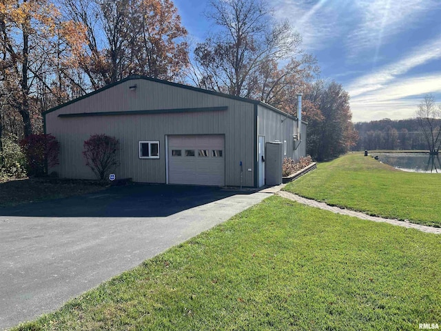 garage featuring a water view and a yard