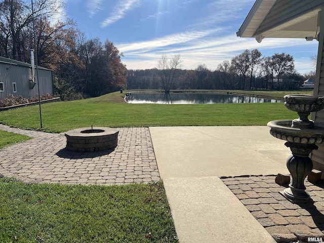 view of patio / terrace with a water view and a fire pit