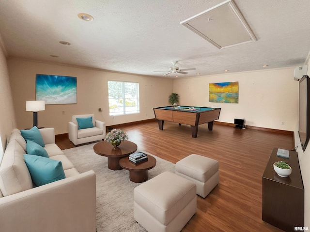 playroom featuring a textured ceiling, a wall mounted AC, ceiling fan, billiards, and hardwood / wood-style floors