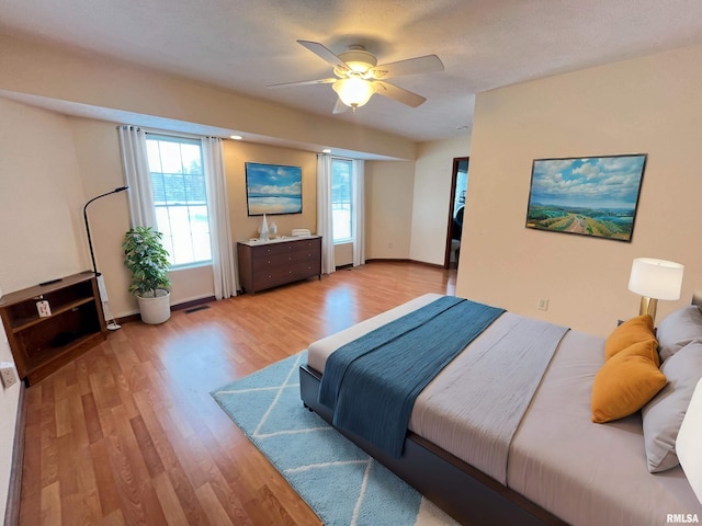 bedroom featuring ceiling fan and light hardwood / wood-style flooring