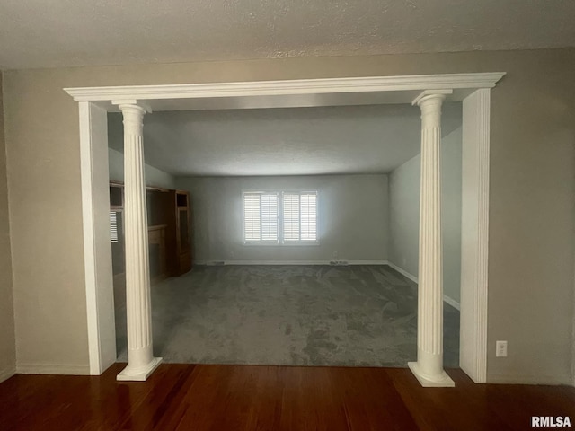 corridor with a textured ceiling and dark hardwood / wood-style floors