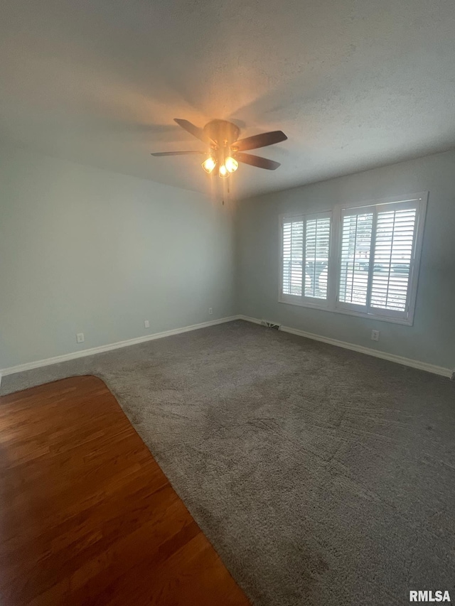 carpeted empty room with ceiling fan