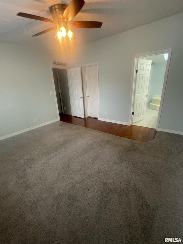 unfurnished bedroom with connected bathroom, ceiling fan, a closet, and dark wood-type flooring