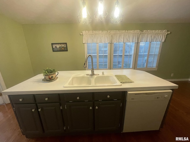 kitchen with dark wood-type flooring, white dishwasher, a center island with sink, sink, and decorative light fixtures