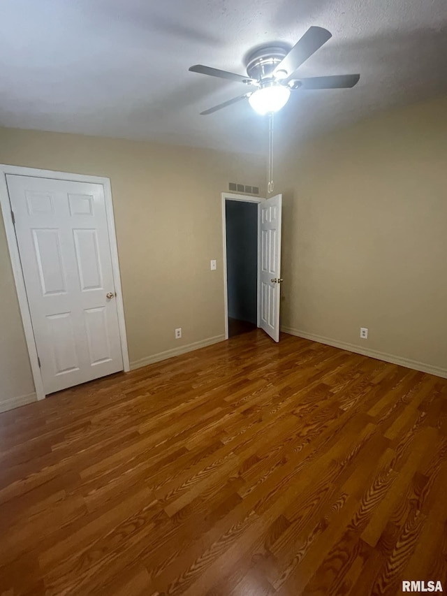 unfurnished bedroom with hardwood / wood-style flooring and ceiling fan