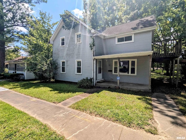 view of front property featuring a front yard and a deck