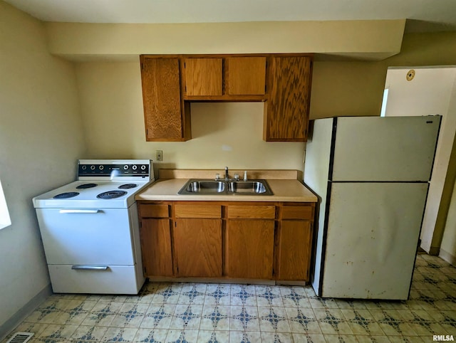 207 E Oak St, Carbondale, IL 62901 - kitchen with white appliances, brown cabinets, light countertops, and light flooring