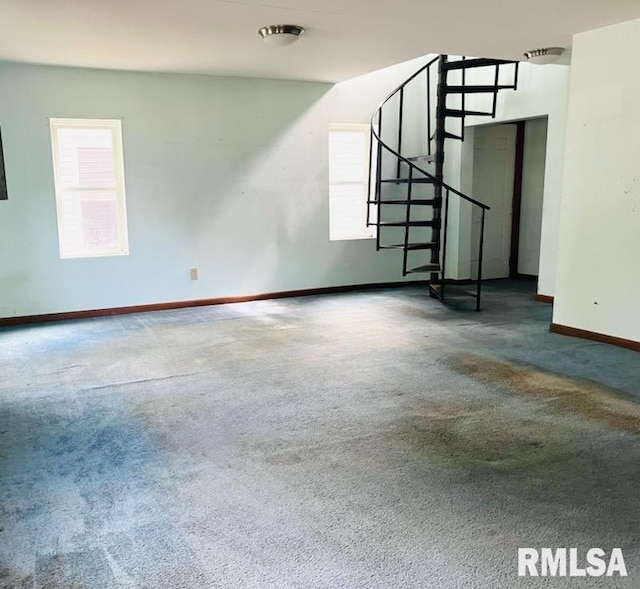 207 E Oak St, Carbondale, IL 62901 - unfurnished living room featuring carpet flooring and stairway