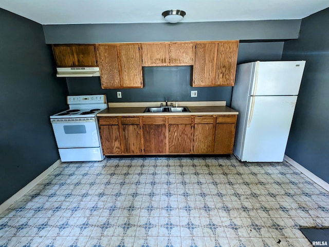 207 E Oak St, Carbondale, IL 62901 - kitchen featuring white appliances, brown cabinets, under cabinet range hood, and light flooring